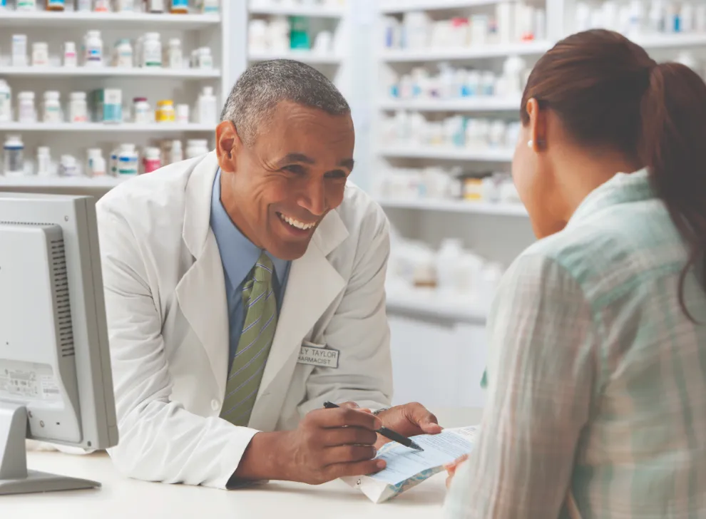 Pharmacist speaking to patient about prescription