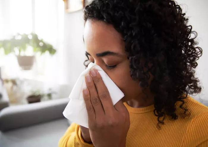Woman Blowing her Nose from a Cold