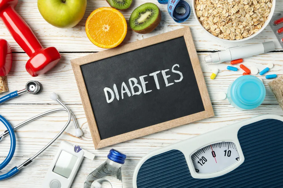 Word diabetes and diabetic accessories on wood background