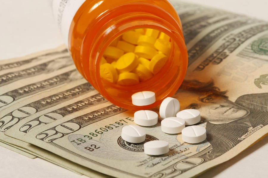 20 dollar bills with bottle of pills