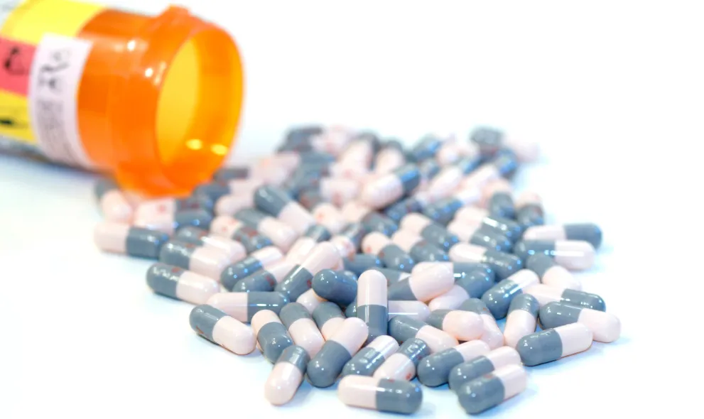 Capsules spilling out of containter