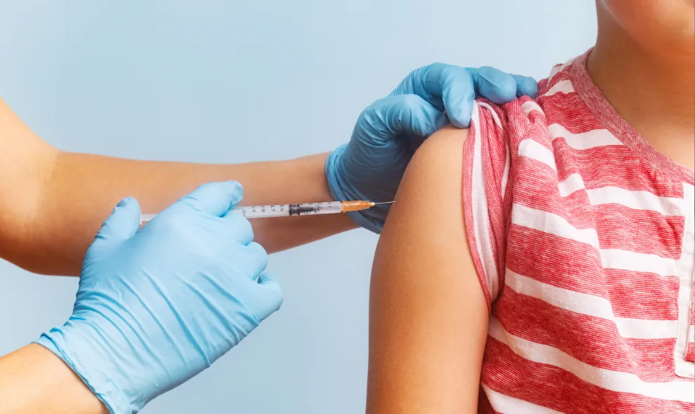 Child receiving vaccine from pediatrician