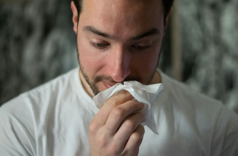 Close up of man using a tissue