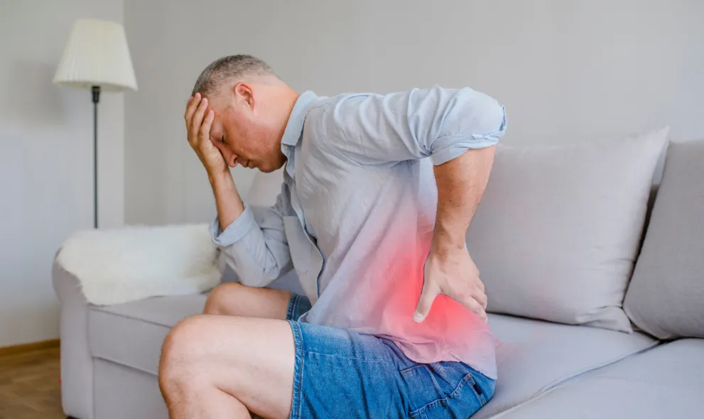Closeup of mature man suffering with back pain