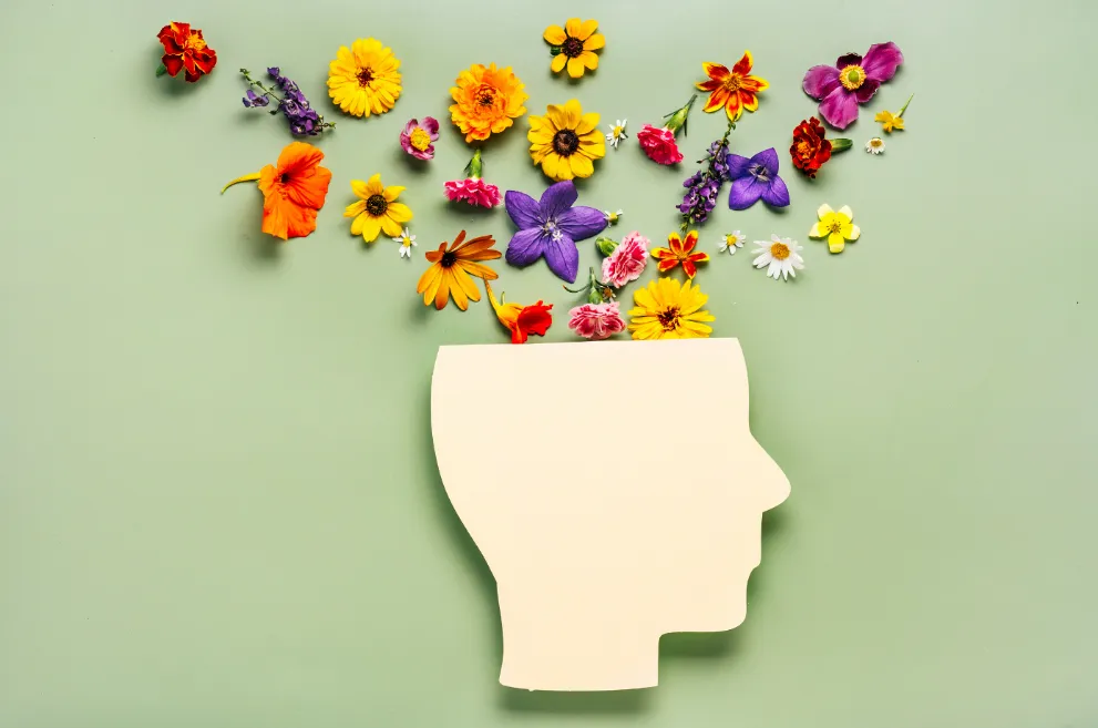 Cutout of head with flowers on green background