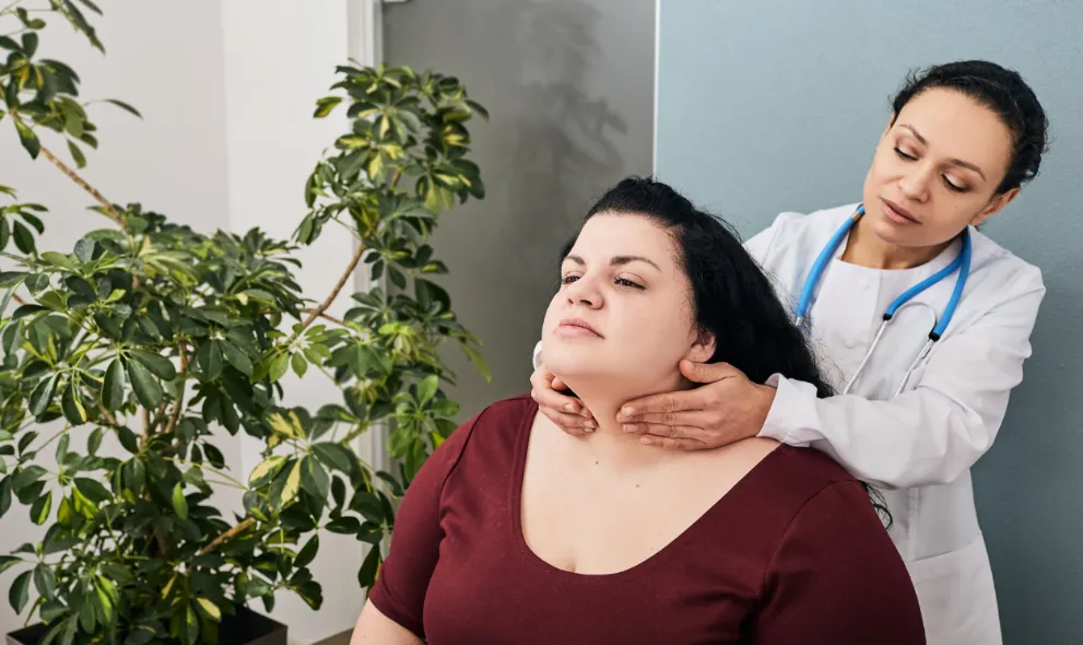 Doctor diagnosing patient with hypothyroidism