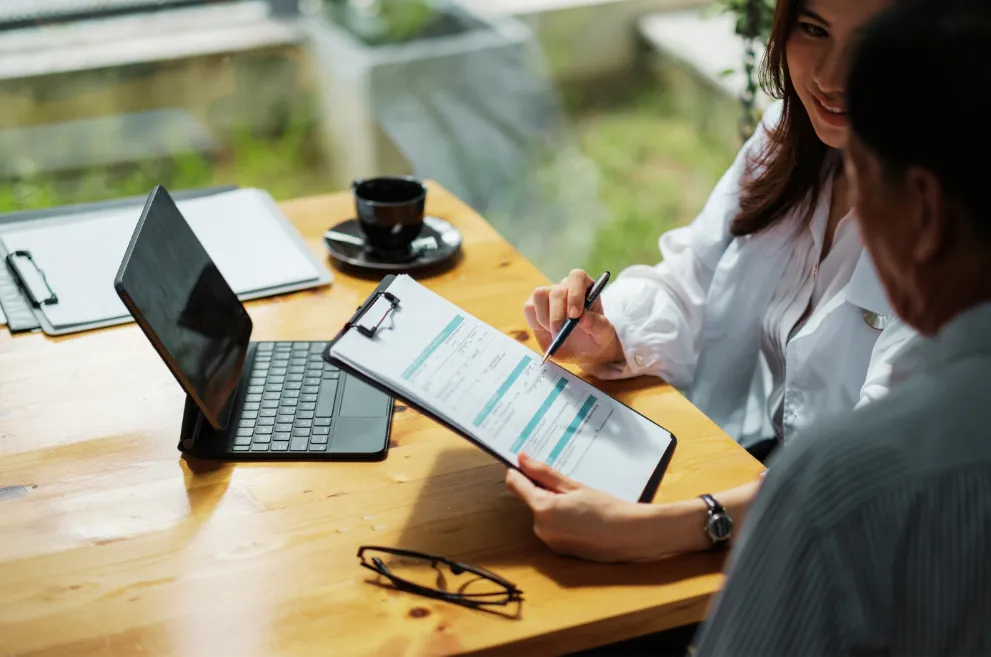 Doctor looking at medical form with patient