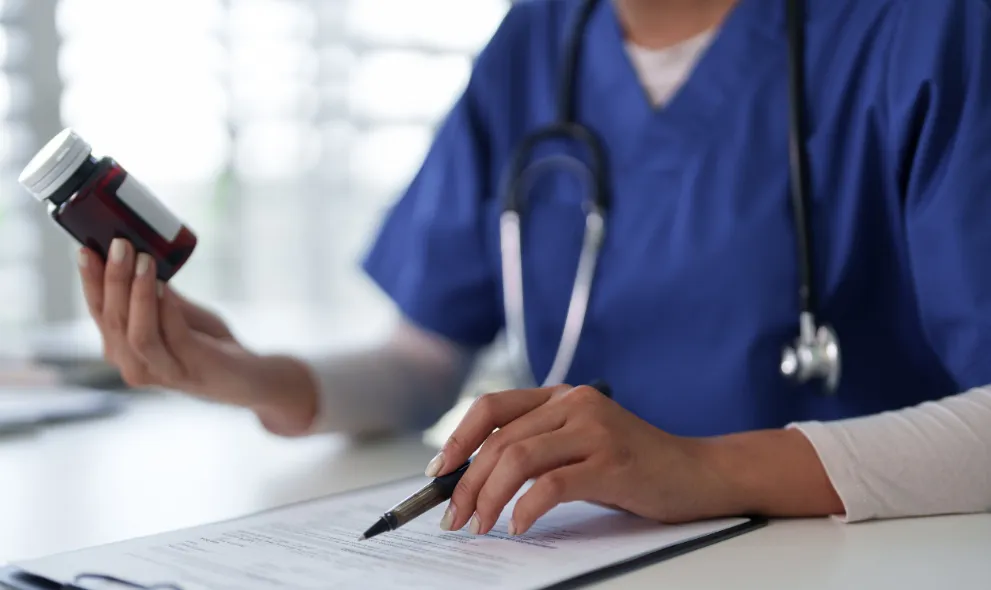 Doctor reviewing patient information holding medication
