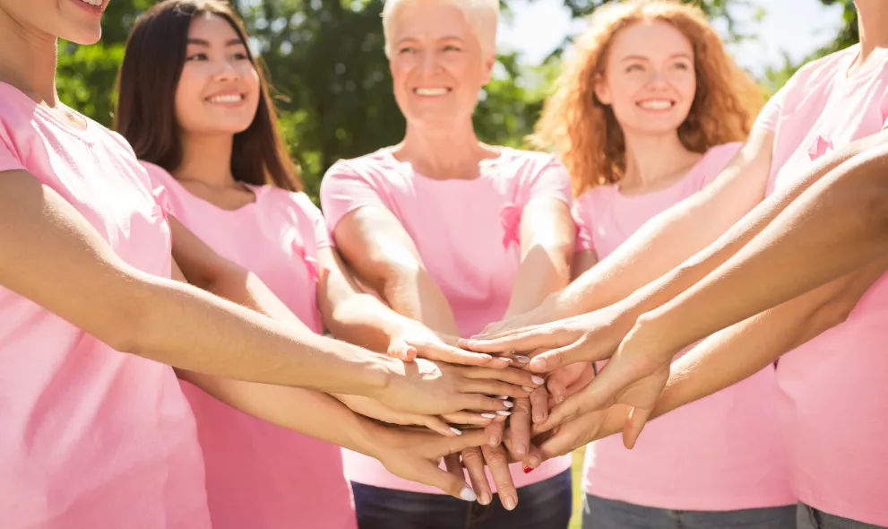 Group of women wearing breast cancer ribbon t-shirts