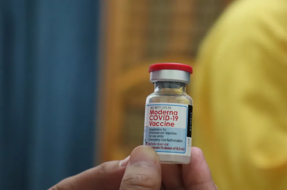 Hand Holding Moderna COVID Vaccine Vial