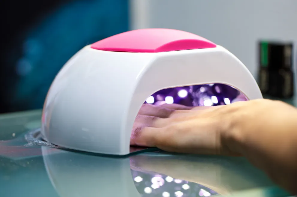Hand inside UV gel lamp
