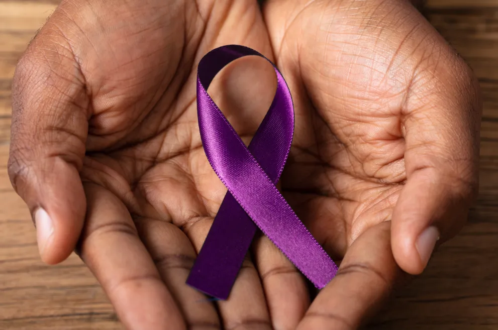 Hands holding purple Alzheimer's Awareness ribbon