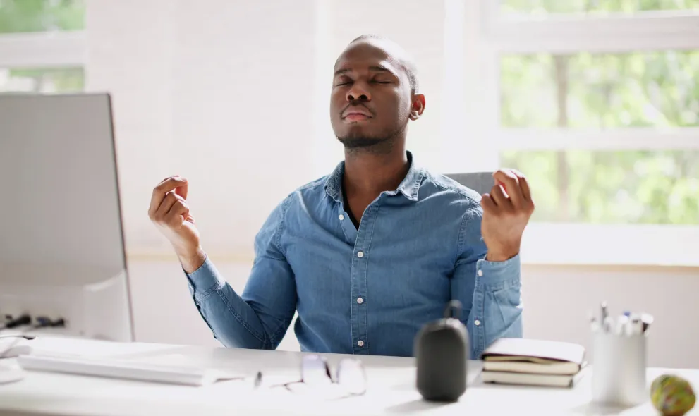 Man doing meditation at this desk