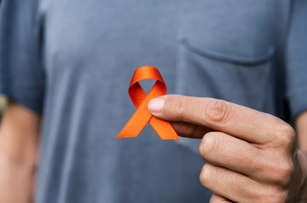 Man holding small orange ribbon