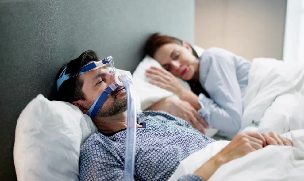 Man sleeping with Cpap machine