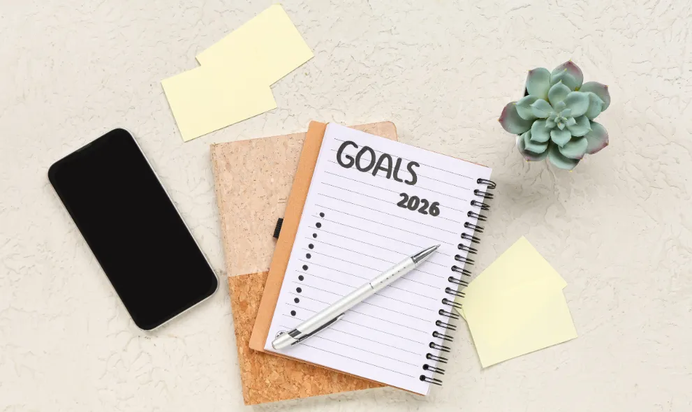 Notebook with 2026 goals mobile phone and paper notes