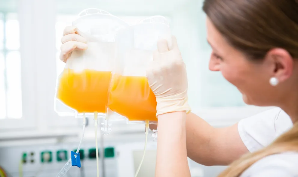 Nurse holding donated plasma