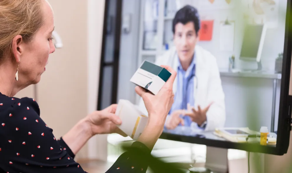 Patient comparing medications while on video call with doctor