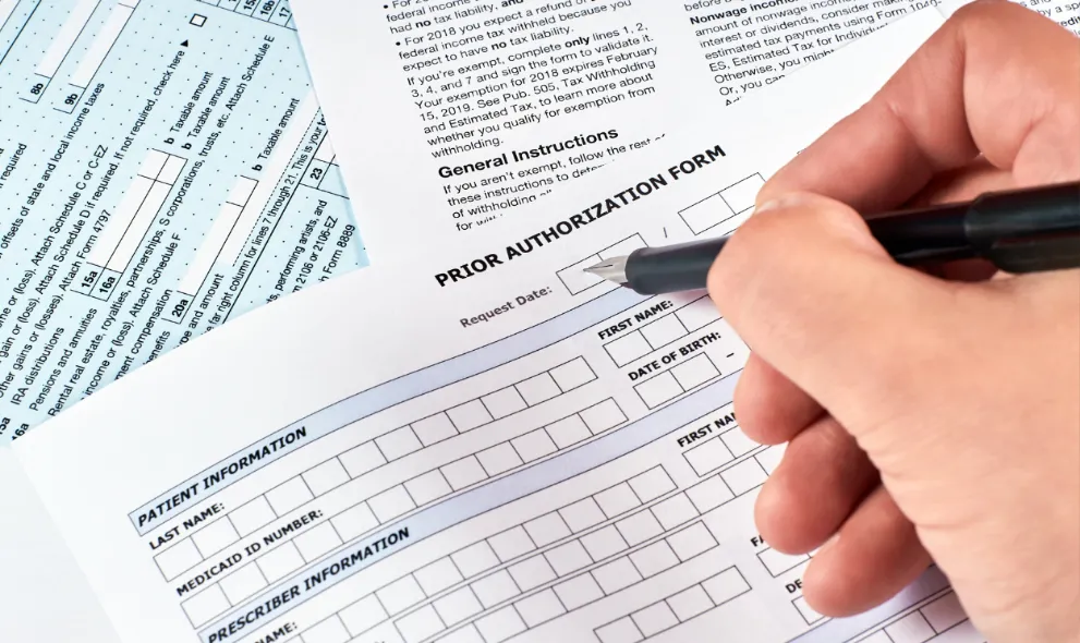 Person filling out prior authorization form
