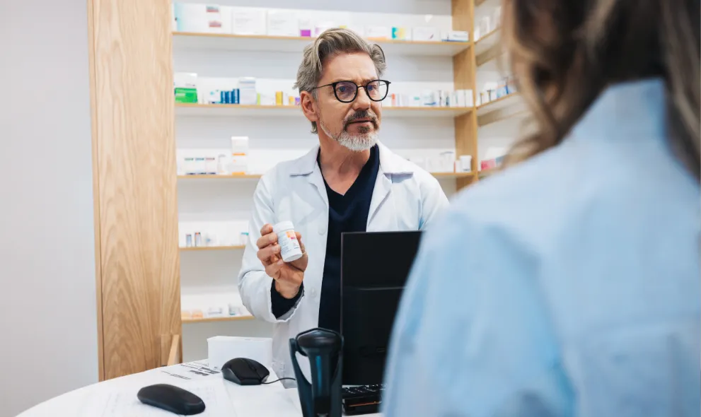 Pharmacist assisting patient over the counter