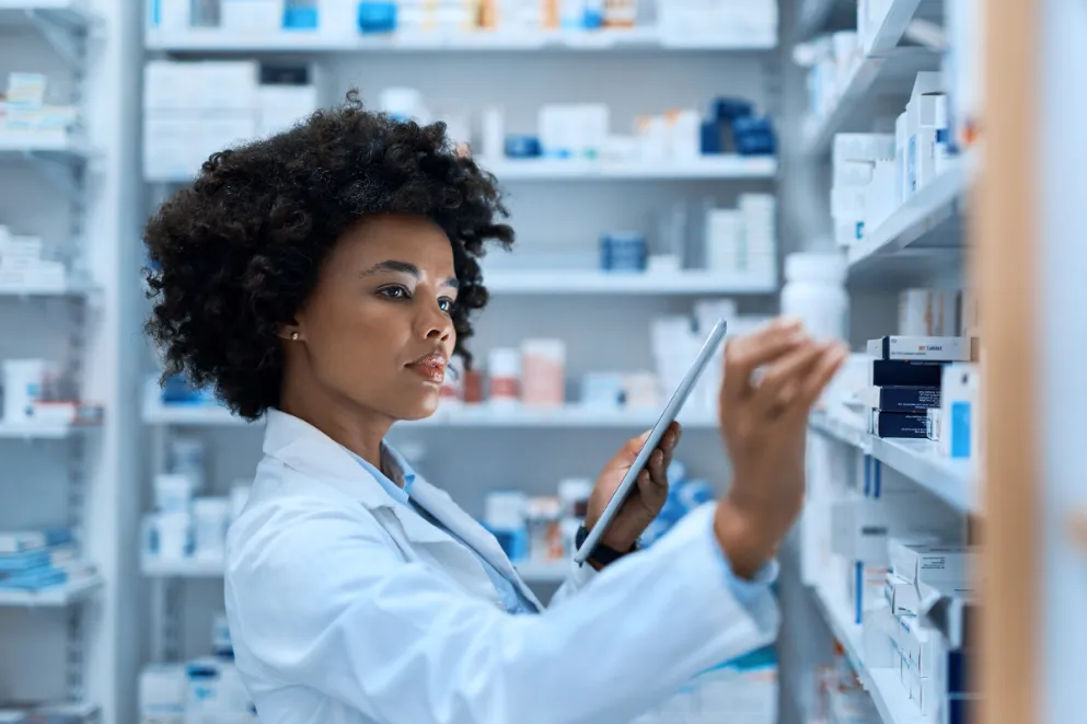 Pharmacist Checking Medications on Shelves