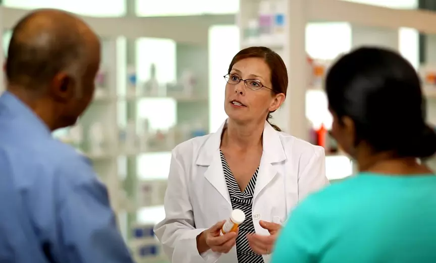 Pharmacist Discussing Medication Options with Couple