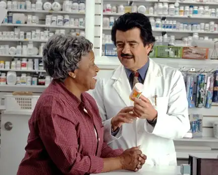 Pharmacist discussing prescription with patient