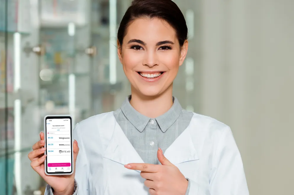 Pharmacist holding phone displaying RxLess app