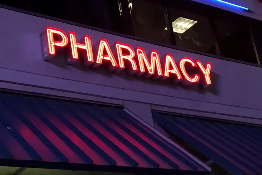Pharmacy neon sign on building
