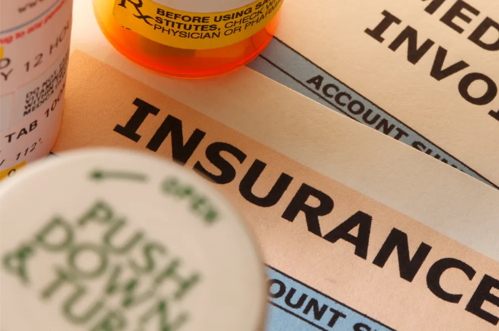 Pill bottles on top of insurance form