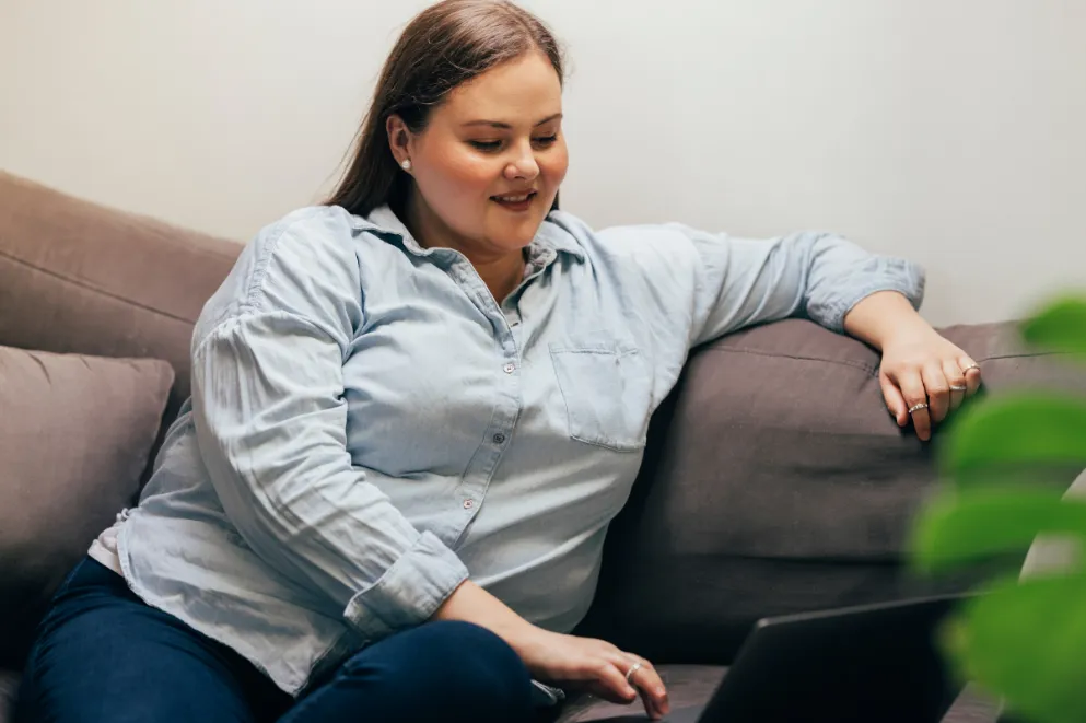Plus-size woman looking at laptop