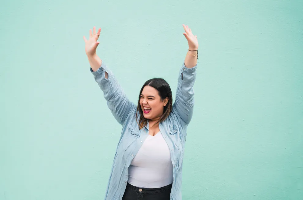 Plus sized woman celebrating