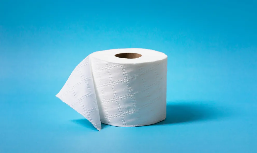 Roll of toilet paper on blue background
