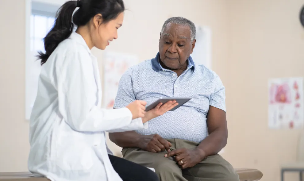 Senior male speaking with this doctor about his treatment plan