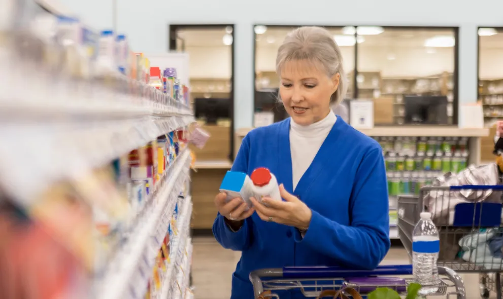 Senior woman compares two over the counter medications