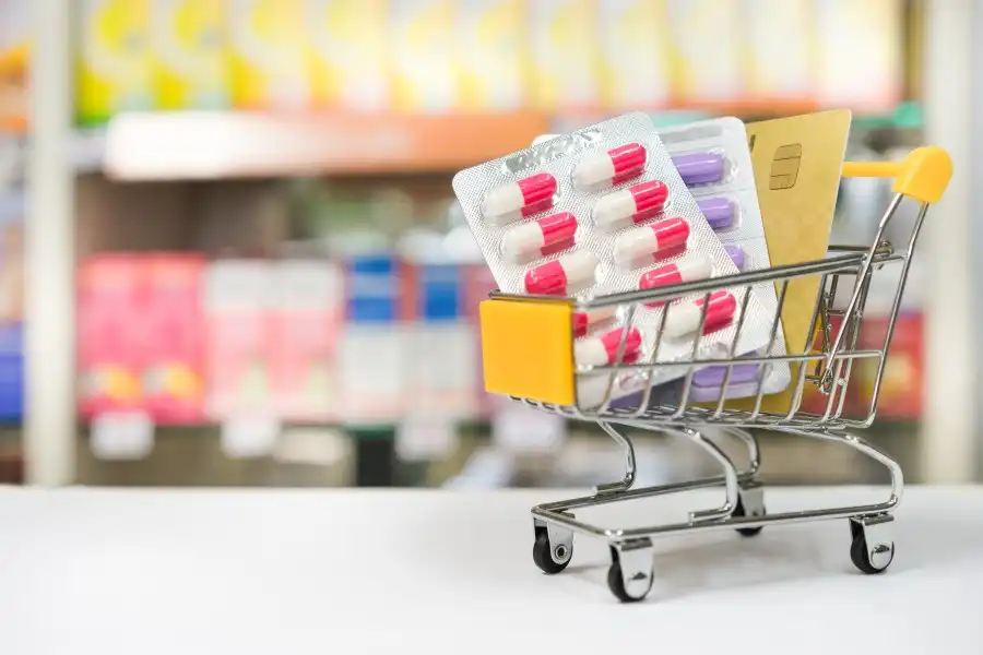 Small shopping cart with blister packs and credit card