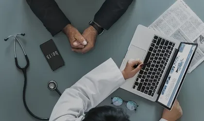 Doctor with patient siscussing results on laptop computer