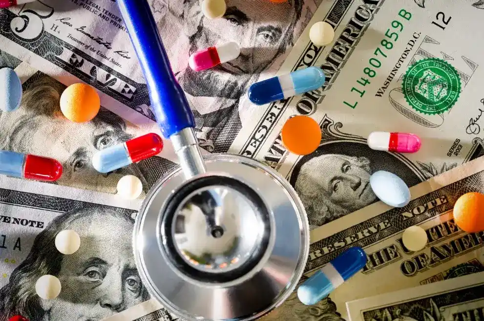 Stethoscope and pills on money