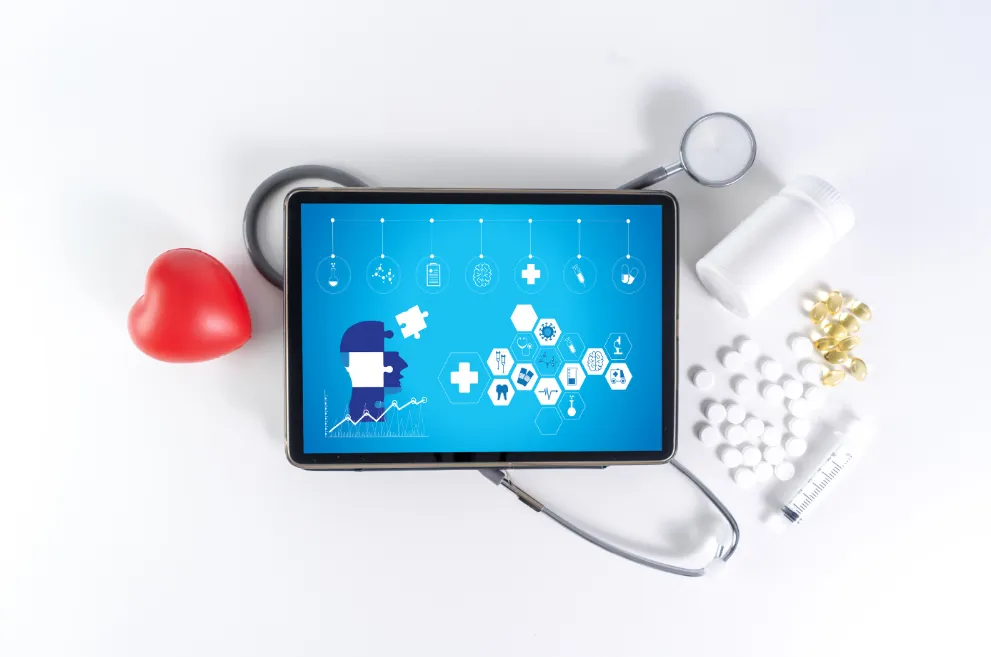 Tablet with medical imagery with medicine and stethoscope in background