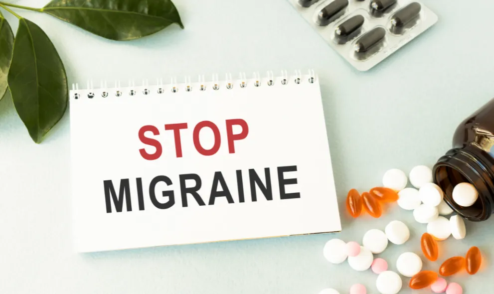 Test on a card Stop Migraine with bottle of medications