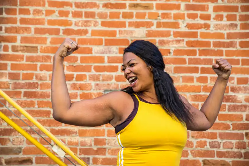 Woman flexing muscles and celebrating