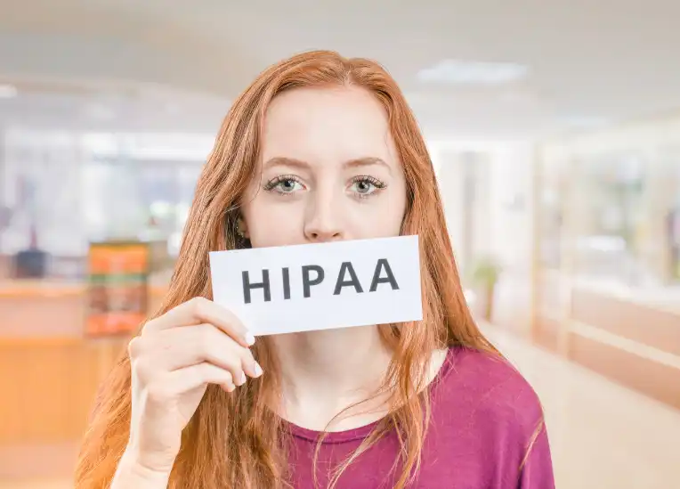 Woman holding HIPAA sign over mouth