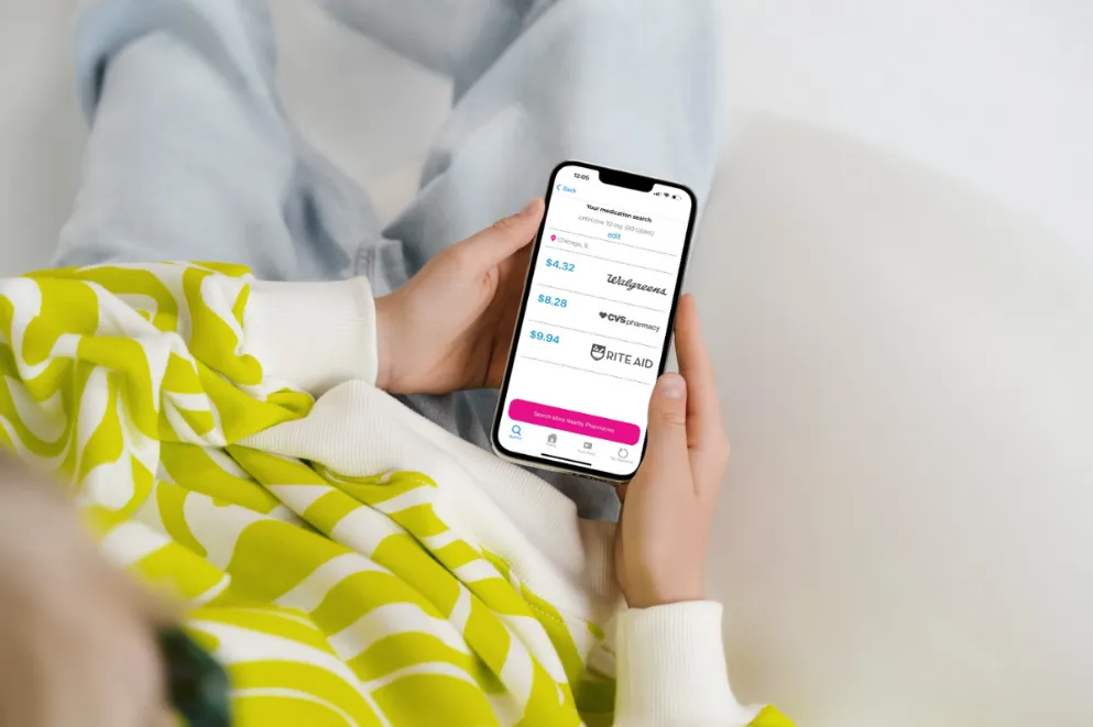 Woman holding phone with RxLess app