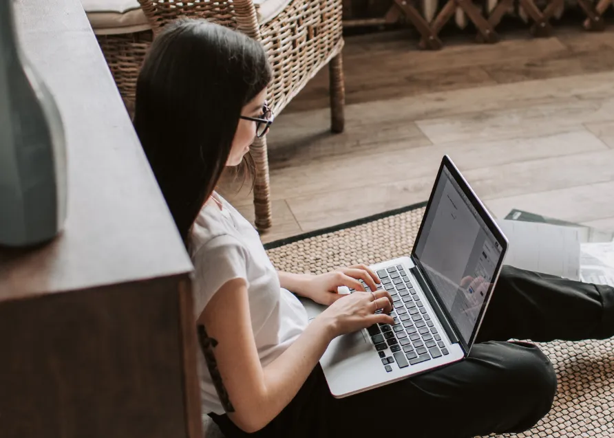 Woman sitting searching on laptop