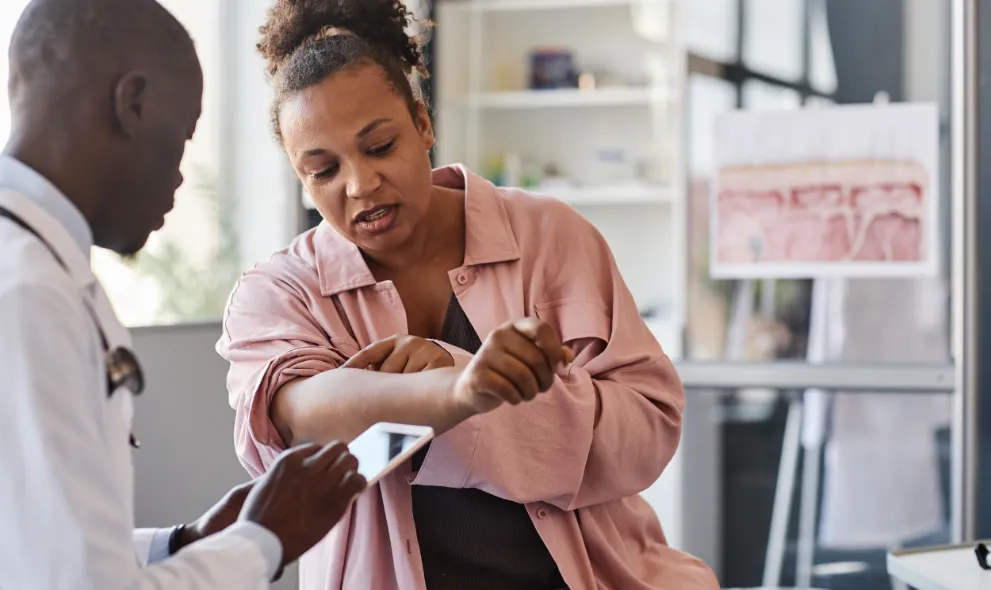 Woman suffering from psoriasis visiting dermatologist