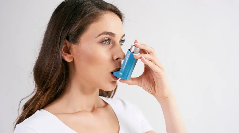 Woman using inhaler