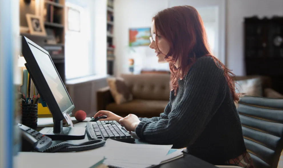 Woman using personal computer at home