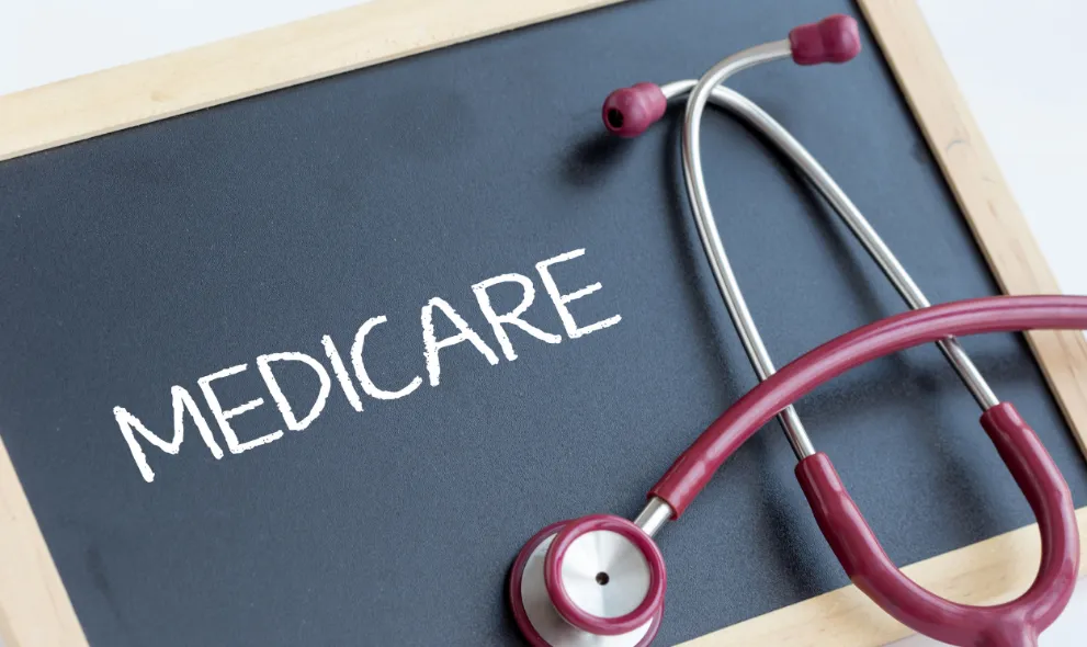 Word medicare on blackboard with stethoscope