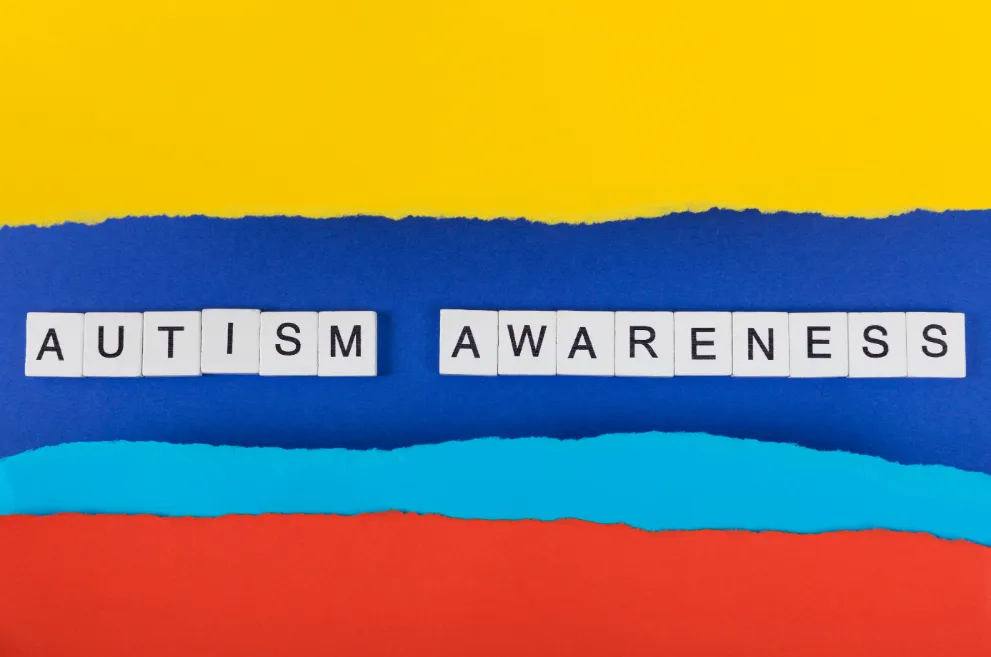 Words Autism Awareness on multicolored background