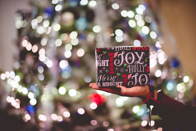 Wrapped present with blurred lights in background